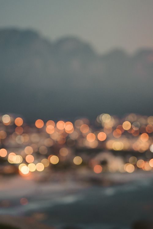 Free Blurry cityscape with colorful bokeh lights capturing an artistic and abstract night scene. Stock Photo