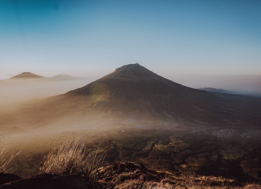 Breathtaking sunrise over Mount Sumbing with misty valleys, showcasing Indonesia's natural beauty.
