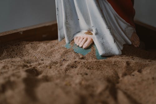 Jesus Christ Figurine on a Sand