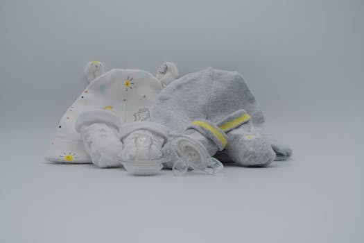 Cozy baby hats, socks, and pacifier in soft pastel colors. Perfect for newborns.