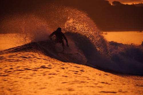 A Man Surfing on Sea Waves