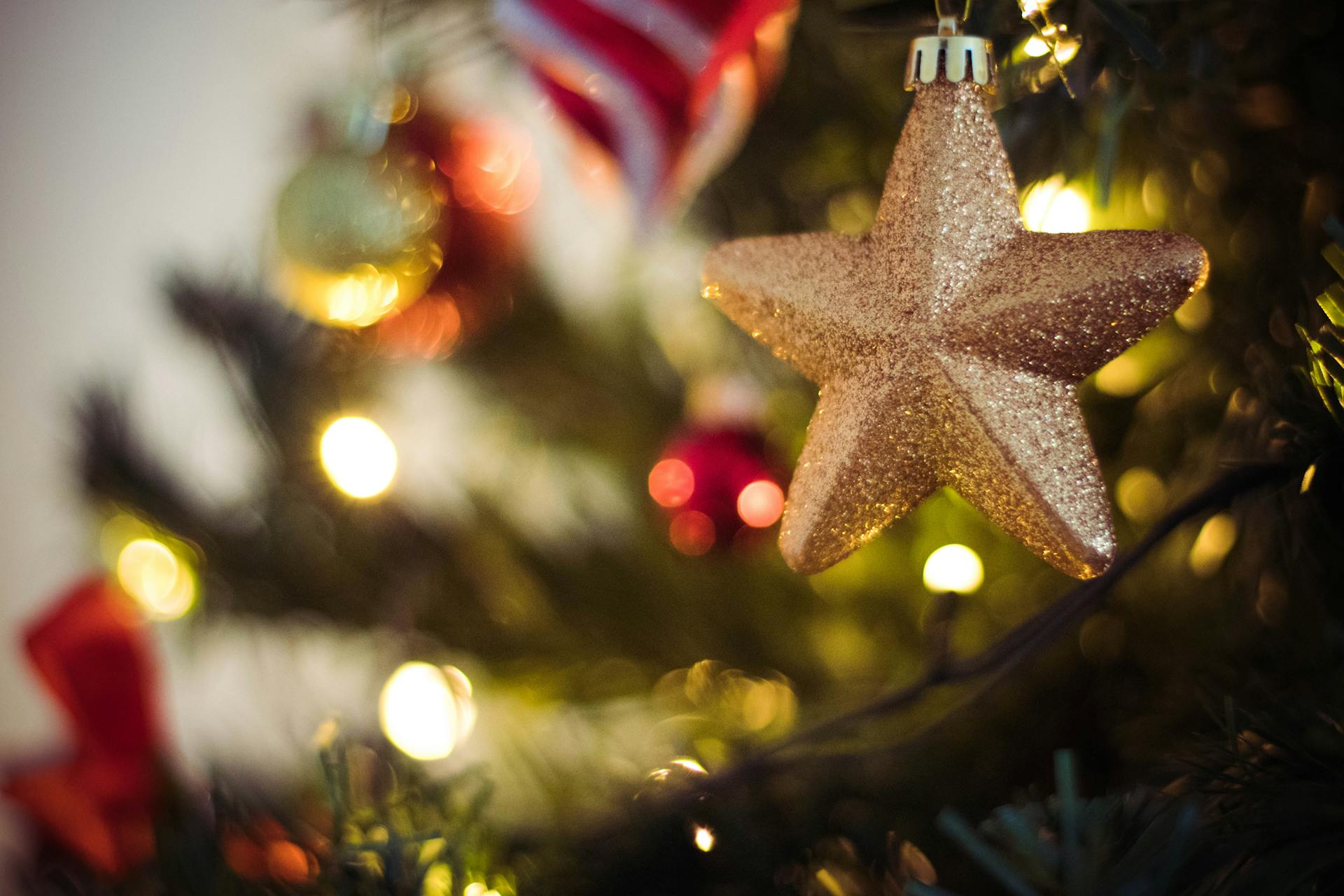 Selective Focus Photography of Gold Star Bauble