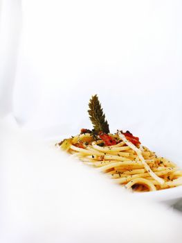 A beautifully presented pasta dish with a touch of herbs and spices, perfect for gourmet cuisine imagery.