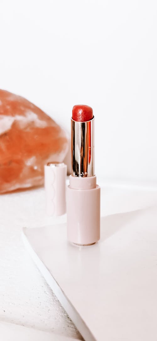 A Red Lipstick on White Surface