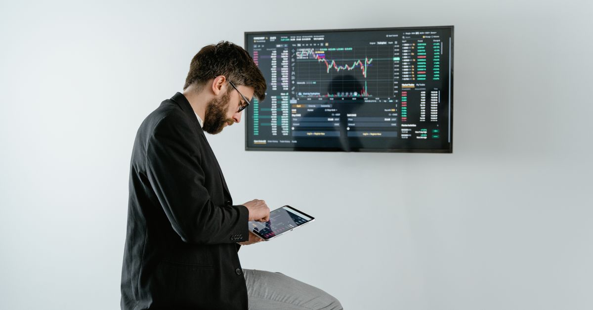 CEO using ChatGPT on tablet in modern boardroom with data visualizations on screen