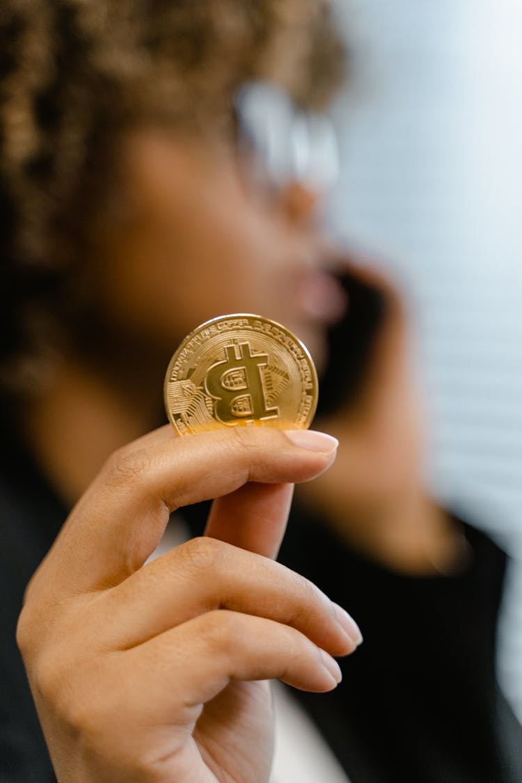 Person Holding Gold Round Coin