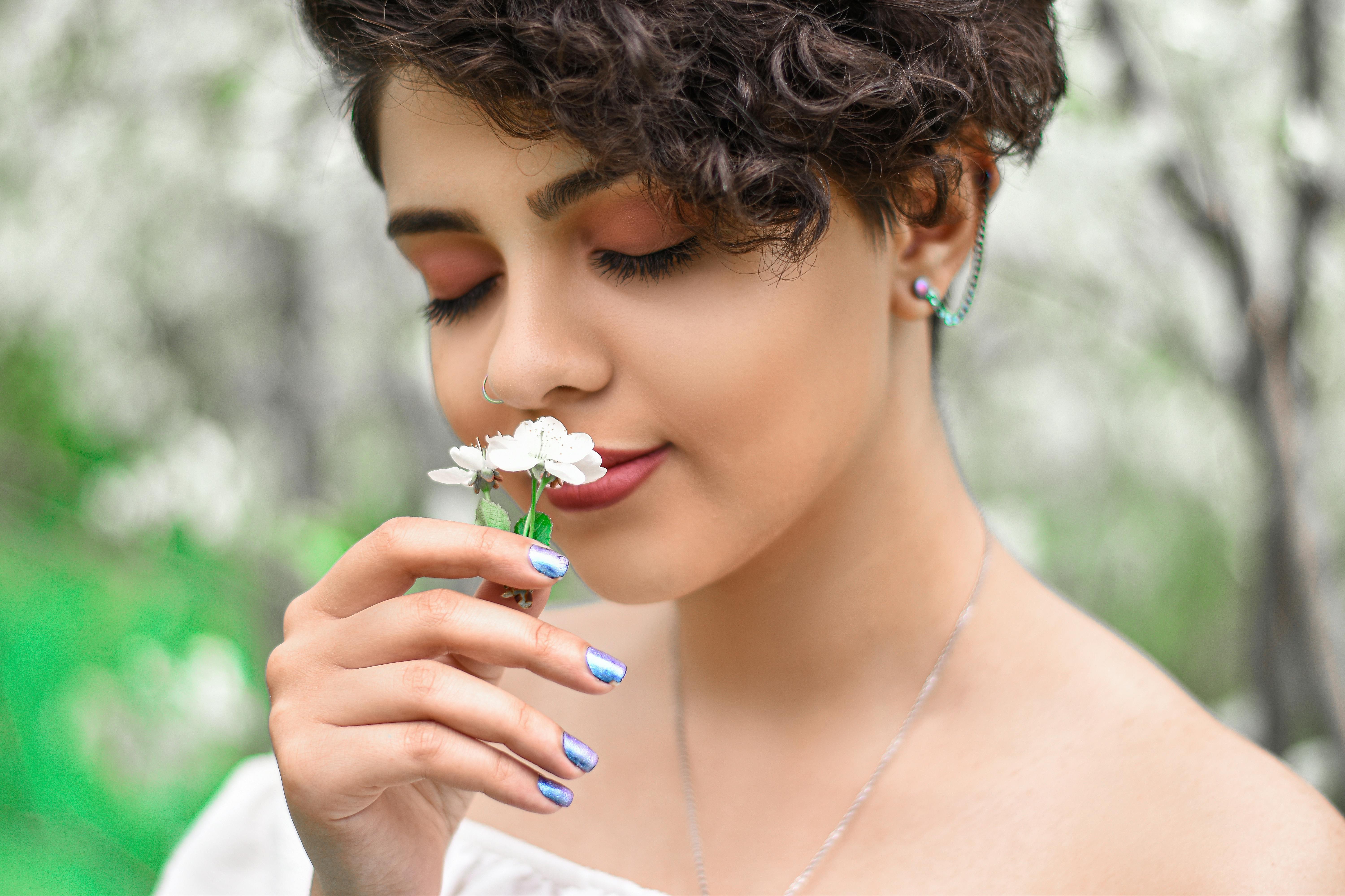 A Beautiful Woman Smelling Flowers · Free Stock Photo