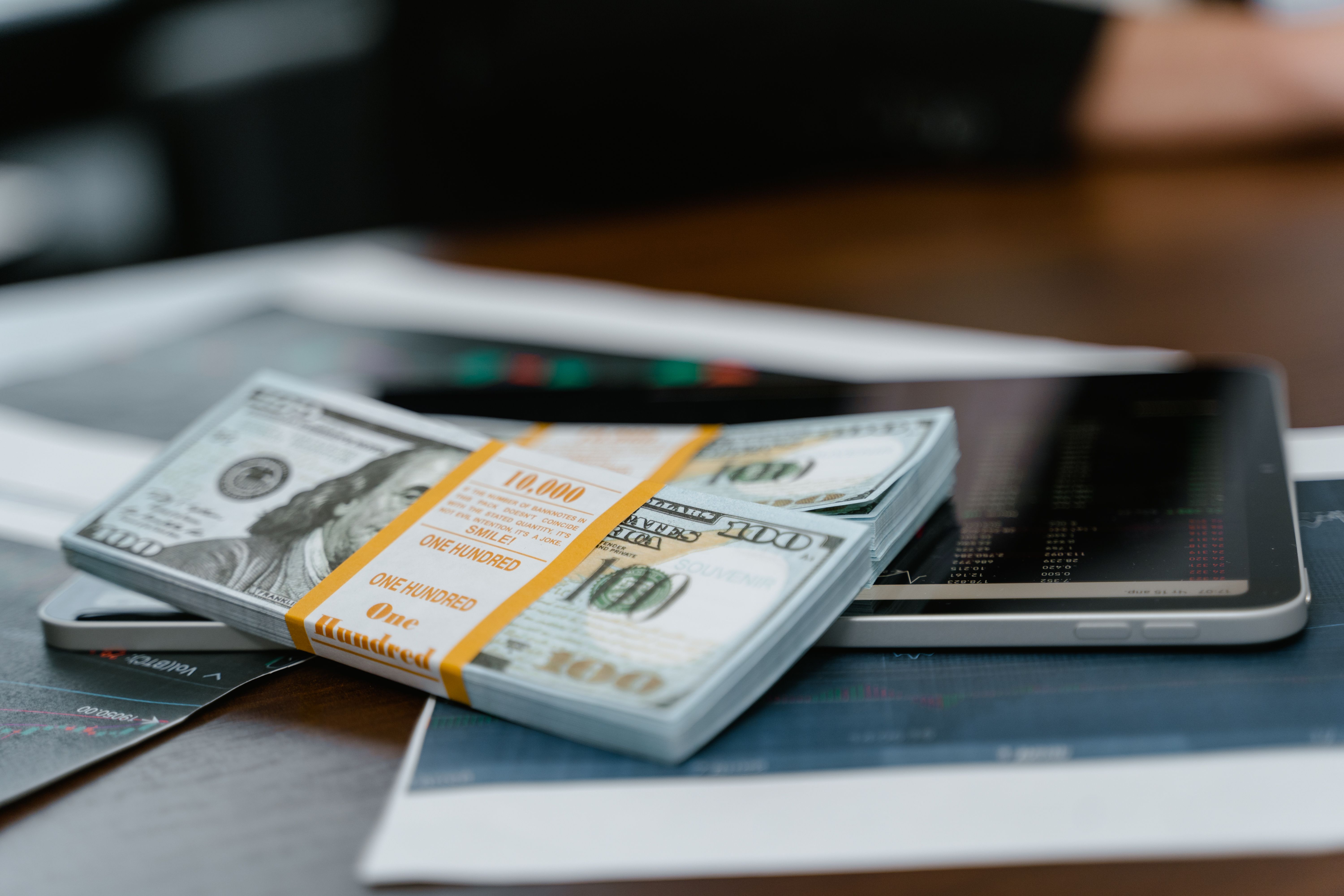 A bundle of 100-dollar bills on a phone