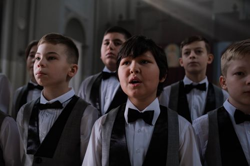 Free A group of young boys performing in a church choir wearing formal attire. Stock Photo