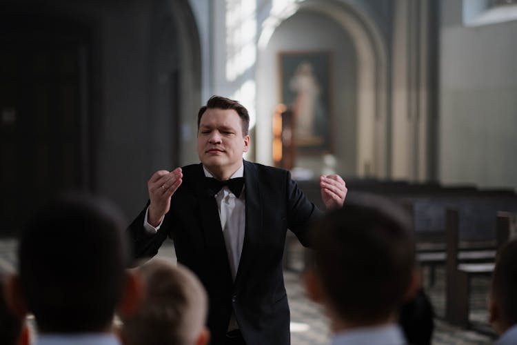 Choir Conductor In Black Suit Doing Hand Signal