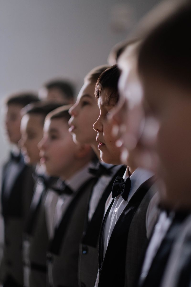 Youth choir of boys singing together in church