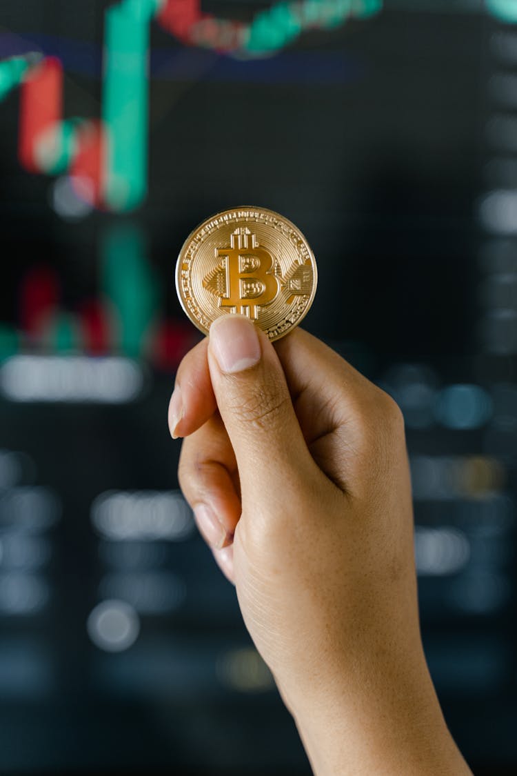 Close-Up Shot Of A Hand Holding A Coin