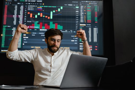 Close-up of a trader annotating a candlestick chart with a pencil
