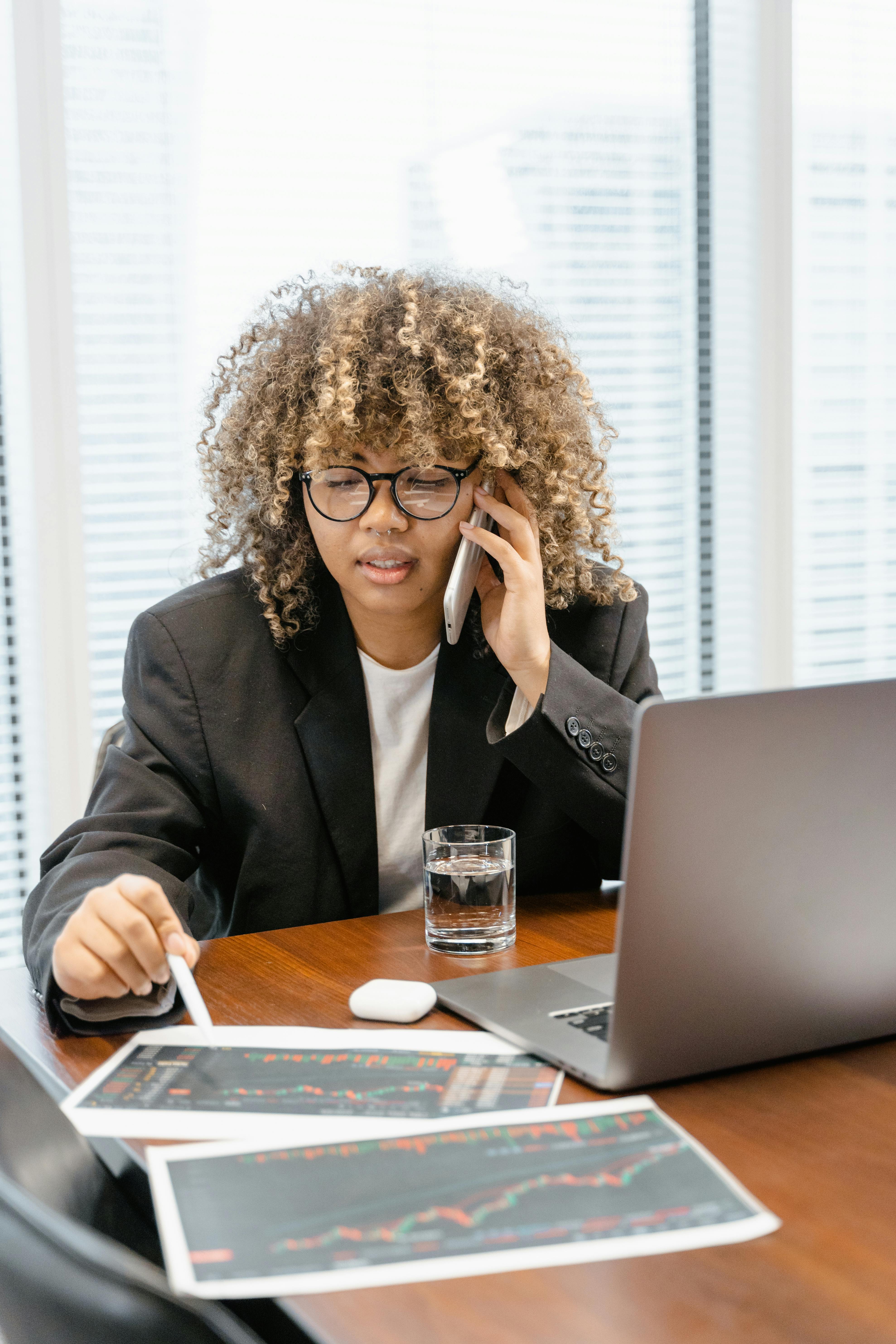 woman in black blazer sitting at the table