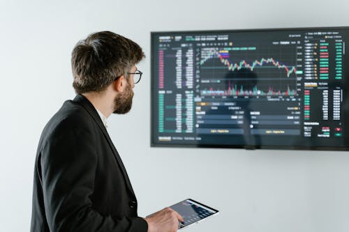 Man in Black Suit Jacket Holding Ipad