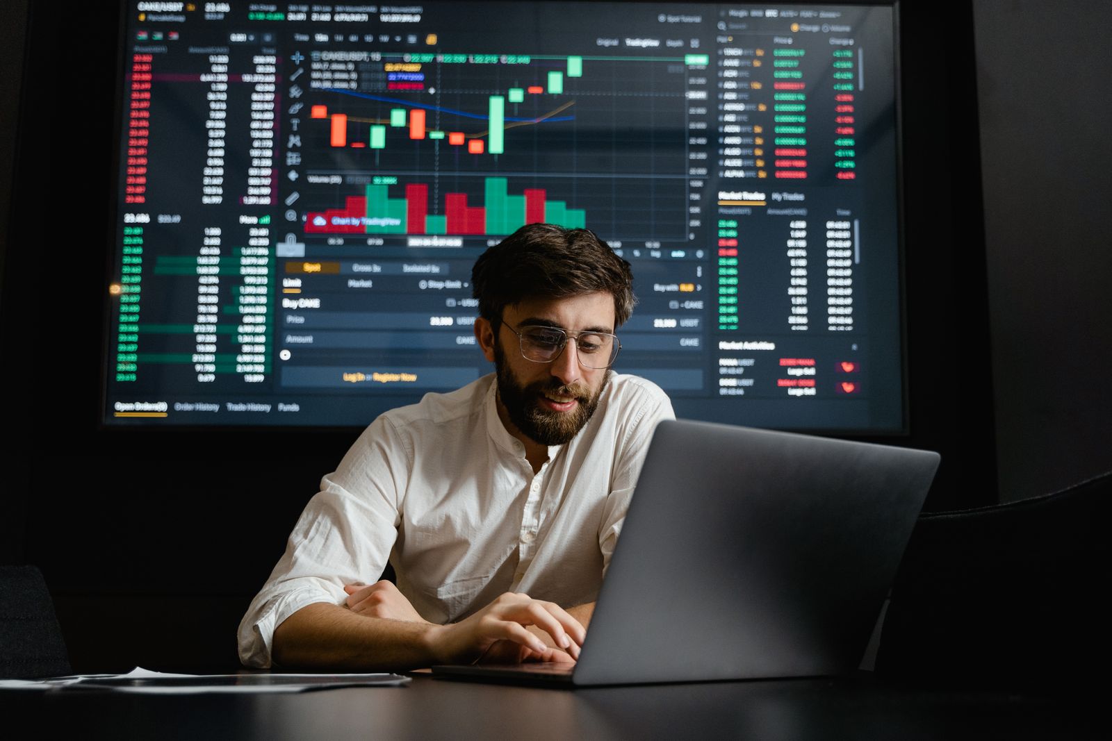 Business professional using a laptop in a bright office.