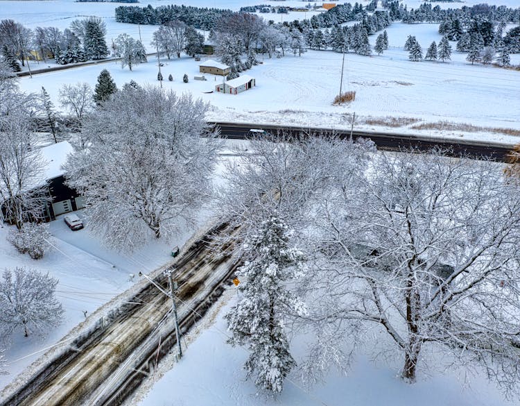 Aerial Shot Of Suburban Area Covered In Snow 