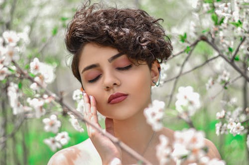 Close-Up Shot of a Pretty Curly-Haired Woman Posing