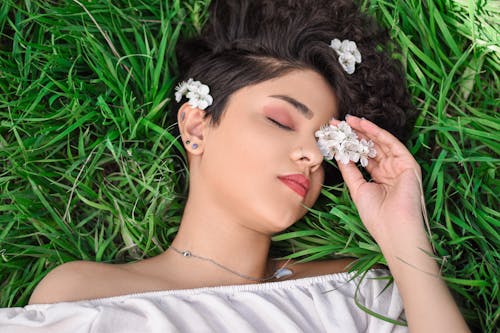 Free Beautiful Woman Lying on Grass Stock Photo