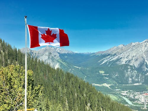 Free Canada Flag With Mountain Range View Stock Photo