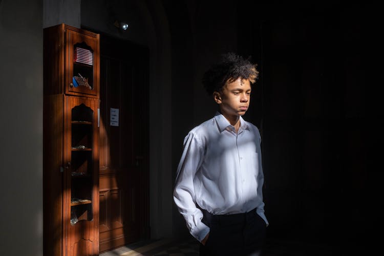 A Teenager In White Long Sleeves Polo Shirt
