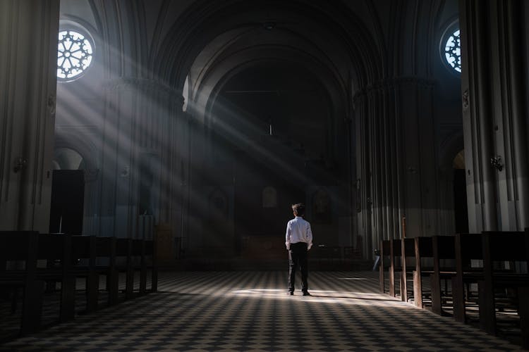 Back View Of A Person Standing Inside A Church