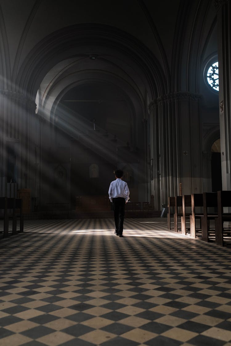 A Boy Walking Down A Church Aisle