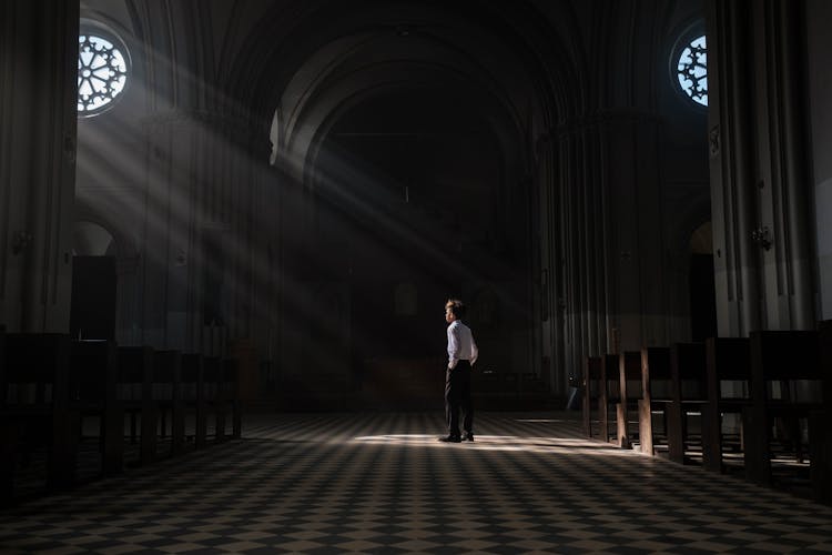 A Young Boy Standing In The Church