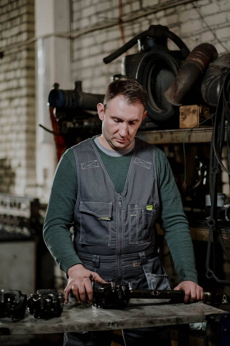 A Mechanic Checking Spare Parts