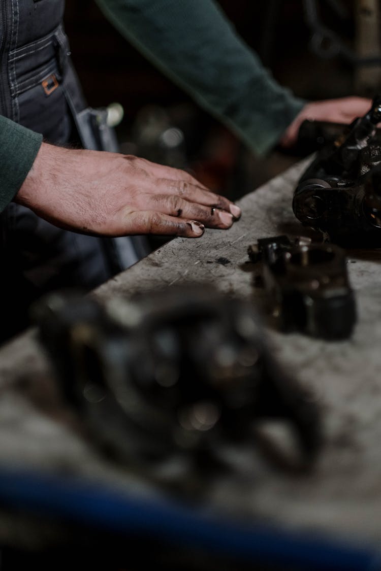 A Mechanic Working On A Dismantle Engine
