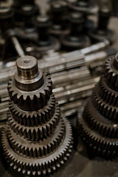 Close-up view of stacked metal gears in a workshop, highlighting precision engineering.