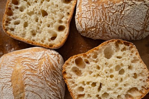 Free Close-up of freshly baked ciabatta bread highlighting its airy texture and crispy crust. Stock Photo