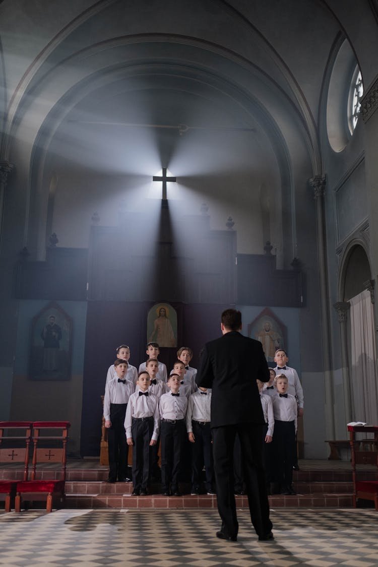 A Conductor Leading A Boys Choir