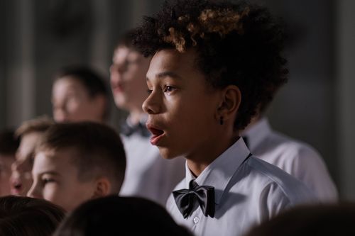 Free A group of boys in a choir singing passionately with focus on African American boy. Stock Photo