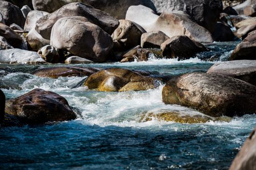 Free Crystal clear water flows over rocks in the scenic mountains of Lavertezzo, Switzerland. Stock Photo