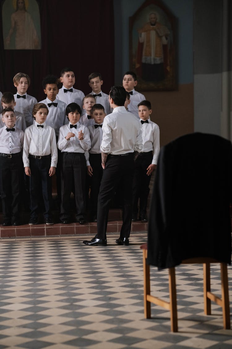 A Boys Choir Practicing Inside The Church