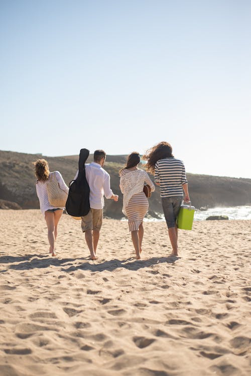 People Walking on Brown Sand