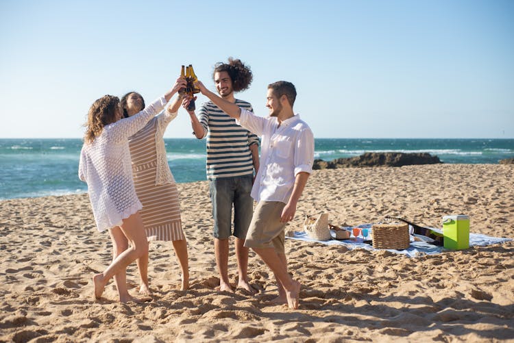 People Toasting On A Beach