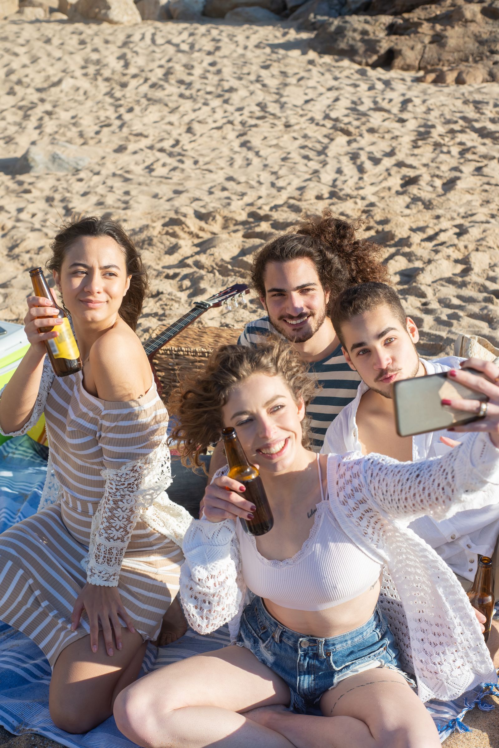 Friends laughing together on the beach during a sunny Miami weekend getaway