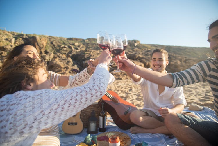 People Toasting Glasses Of Wine