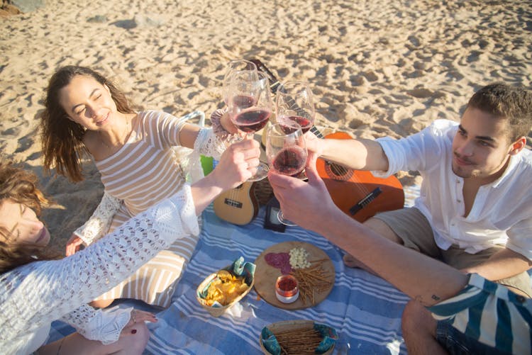 People Toasting On A Beach