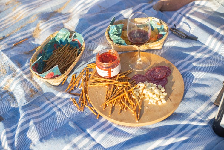 Charcuterie Board And Wine On A Picnic Blanket