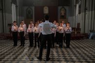 Man Standing in Front of Group of Boys Holding Lighted Candles