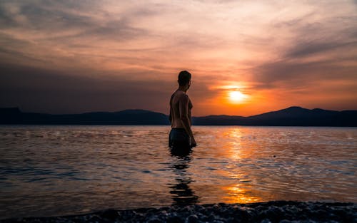 A Man Looking at the Scenic Sunset