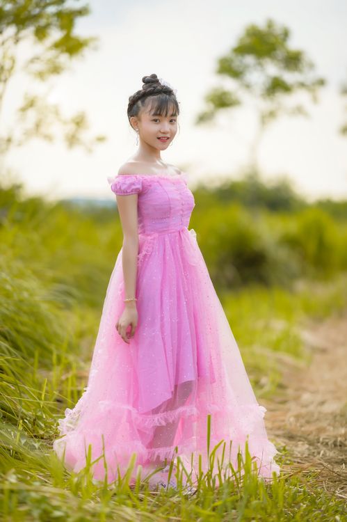 A Girl in Pink Dress Standing on the Field · Free Stock Photo