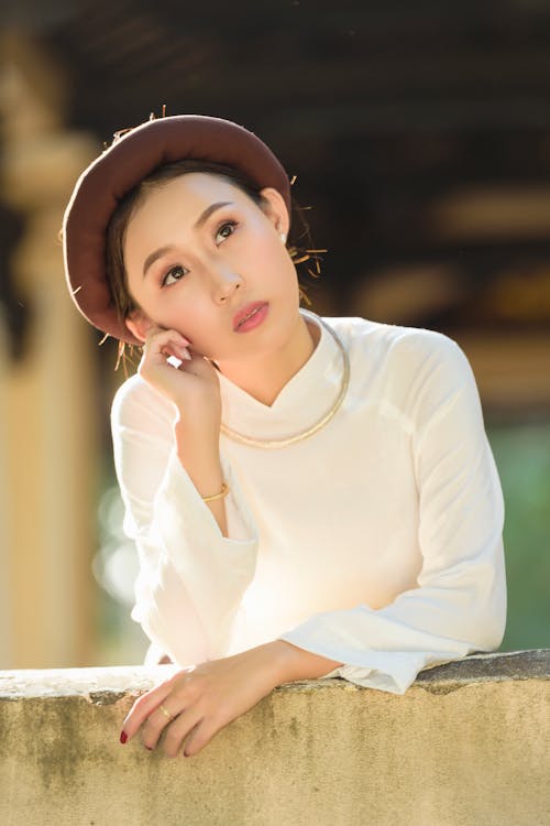 Free A Woman in White Long Sleeves Wearing a Hat Stock Photo