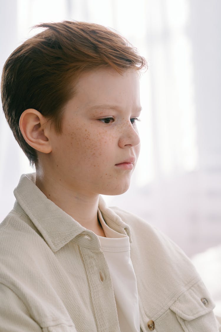 A Young Boy With Freckles On His Face