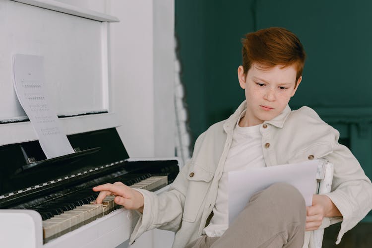 Boy Learning To Play The Piano