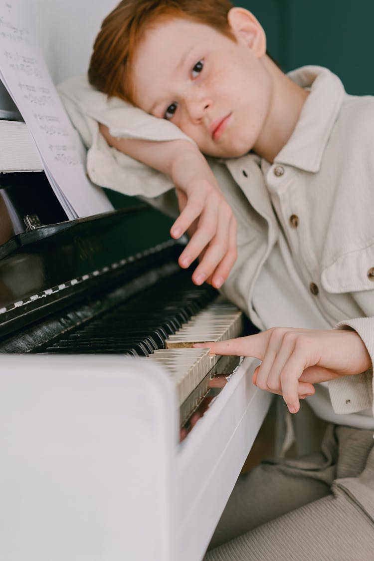 A Boy Leaning On The Piano