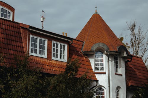 Facade of White Concrete House with Clay Roof Tiles